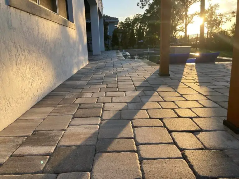 Sealed paver walkway leading along the house to the pool at sunset
