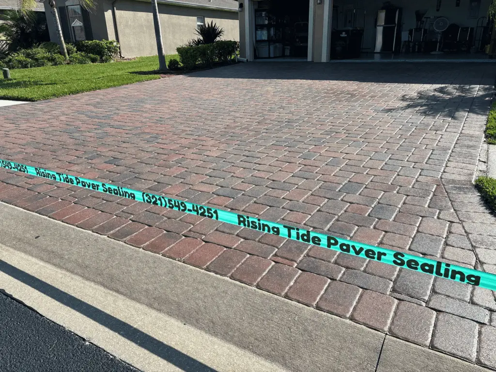 Red and charcoal multicolor paver driveway freshly sealed in Brevard County, Florida