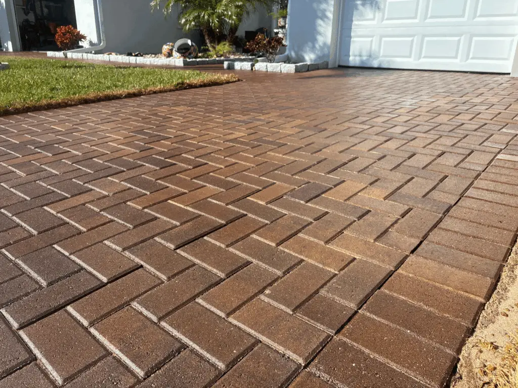 Red-brown herringbone paver driveway with a gloss sealed finish in Brevard County, Florida