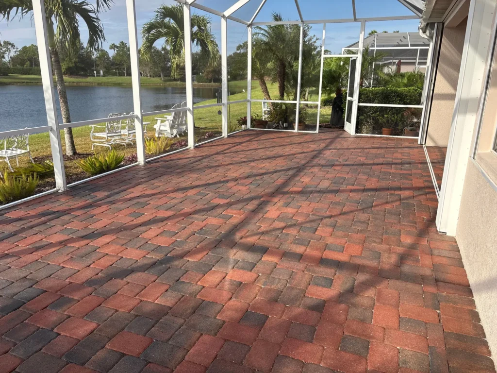 Sealed red brick paver patio inside a lakefront screened lanai in Brevard County, Florida