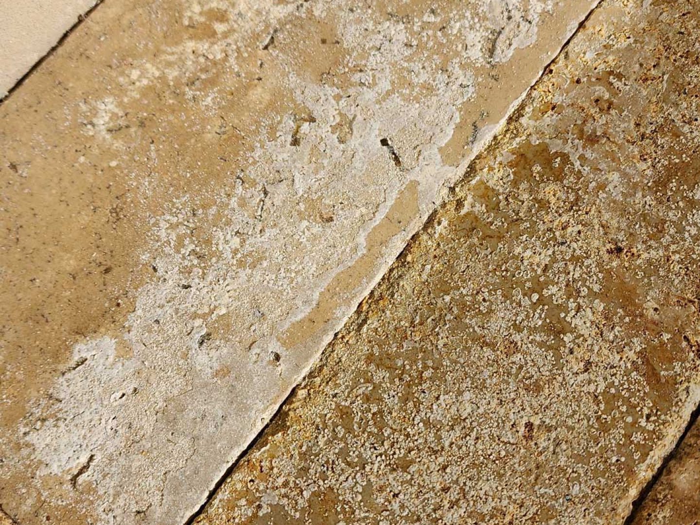 Close-up of sealer delamination and surface failure on pool deck pavers